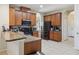 Functional kitchen with brown cabinets, tile backsplash, and stainless steel appliances at 1502 Fern Bay Ct, Orlando, FL 32824