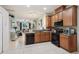 View of kitchen showcasing wood cabinets, tile flooring, and an open layout to the living room at 1502 Fern Bay Ct, Orlando, FL 32824