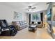 Spacious living room features tile floors, comfortable seating, and a stylish stone accent wall at 1502 Fern Bay Ct, Orlando, FL 32824