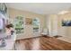 Bright living room with hardwood floors, arched windows, and a cozy chair at 1502 Fern Bay Ct, Orlando, FL 32824