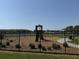 A community playground with a slide, swings, and other play structures near the lake at 1502 Fern Bay Ct, Orlando, FL 32824
