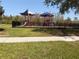 A community playground with multiple play structures and swings behind a black fence at 1502 Fern Bay Ct, Orlando, FL 32824