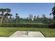 Community tennis and basketball court behind a green fence in a landscaped area at 1502 Fern Bay Ct, Orlando, FL 32824