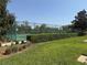 A fenced-in tennis court and basketball court surrounded by green hedges and green grass at 1502 Fern Bay Ct, Orlando, FL 32824