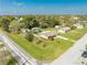 Picturesque aerial view of a charming home amidst lush greenery, boasting a well-maintained lawn and serene surroundings at 1518 Mississippi Ave, St Cloud, FL 34769
