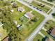 Overhead view capturing a house on a generous green lot, part of a quiet neighborhood with nearby recreational area at 1518 Mississippi Ave, St Cloud, FL 34769