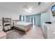 Primary bedroom features wood-style flooring, an ensuite bath, and plenty of closet space at 1518 Mississippi Ave, St Cloud, FL 34769