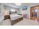 Bright bedroom features a neutral palette, tile floors, and a mounted television at 1518 Mississippi Ave, St Cloud, FL 34769