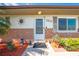 Inviting entryway with a decorated door, brick accents, and manicured garden at 1518 Mississippi Ave, St Cloud, FL 34769