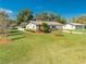 Alluring single-story home with manicured lawn, verdant landscaping, and a flagpole, offering a cozy residential charm at 1518 Mississippi Ave, St Cloud, FL 34769