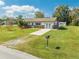 Charming single-story home with a well-manicured lawn, spacious driveway, and a mailbox in a tranquil neighborhood at 1518 Mississippi Ave, St Cloud, FL 34769