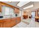 Wood cabinets and granite countertops complement the bright kitchen lighting and white tile backsplash at 1518 Mississippi Ave, St Cloud, FL 34769
