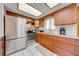 Updated kitchen features stainless steel appliances, granite countertops, and ample cabinet space at 1518 Mississippi Ave, St Cloud, FL 34769