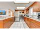 Bright kitchen features wood cabinets, stainless steel appliances and white backsplash with granite countertops at 1518 Mississippi Ave, St Cloud, FL 34769