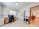 Home office with storage shelves, natural light, and a view through doorway to living area at 1518 Mississippi Ave, St Cloud, FL 34769
