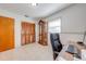 Office room featuring a work desk, wood-look closet doors, and a glass display cabinet at 1518 Mississippi Ave, St Cloud, FL 34769