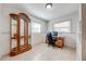 Office space with tile flooring, built-in shelving, and a large glass display cabinet at 1518 Mississippi Ave, St Cloud, FL 34769