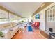 Relaxing screened-in lanai with comfortable seating and a TV, an inviting extension of indoor living at 1518 Mississippi Ave, St Cloud, FL 34769