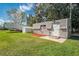 Exterior view of a storage shed with landscaping and a camper nearby, providing ample storage on the property at 1518 Mississippi Ave, St Cloud, FL 34769