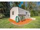 Exterior view of a storage shed, surrounded by meticulous landscaping and a convenient hose hookup at 1518 Mississippi Ave, St Cloud, FL 34769
