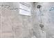 Walk-in shower features elegant tile work and a modern shower head at 1518 Mississippi Ave, St Cloud, FL 34769