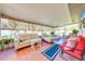 Sunroom with tile floors, comfortable seating, and views of the backyard at 1518 Mississippi Ave, St Cloud, FL 34769