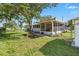Spacious backyard view with lush greenery and a screened-in patio at 1622 Marlin St, St Cloud, FL 34771