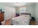 Comfortable bedroom with hardwood floors, closet space, and a bright window at 1622 Marlin St, St Cloud, FL 34771