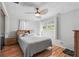 Relaxing bedroom features a ceiling fan, light-colored walls, and a view of the outdoors at 1622 Marlin St, St Cloud, FL 34771
