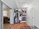 Walk-in closet with ample shelving for storage, clothing racks, and tile flooring at 1622 Marlin St, St Cloud, FL 34771