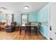 Cozy dining area with a wooden table, adjacent to a comfortable living space at 1622 Marlin St, St Cloud, FL 34771
