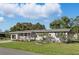Inviting single-story home with a lovely front porch and lush green lawn at 1622 Marlin St, St Cloud, FL 34771