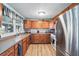 Bright kitchen with stainless steel refrigerator, light wood cabinets, and updated countertops at 1622 Marlin St, St Cloud, FL 34771