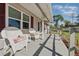 Relaxing front porch with wicker chairs, perfect for enjoying the outdoors at 1622 Marlin St, St Cloud, FL 34771