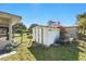 View of a backyard shed with a garden and chain-link fence at 1622 Marlin St, St Cloud, FL 34771