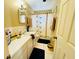 Well-lit bathroom featuring ample counter space, decorative accents, and a shower-tub combination at 205 Elinor S Ave, Dundee, FL 33838