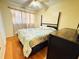 Bedroom featuring a bed, wood floors, ceiling fan, and natural light from a window at 205 Elinor S Ave, Dundee, FL 33838