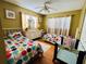 Shared bedroom with twin beds, colorful polka dot linens, and a coordinating neutral dresser at 205 Elinor S Ave, Dundee, FL 33838