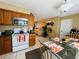 Well-lit kitchen and dining area with an open layout and tiled floors at 205 Elinor S Ave, Dundee, FL 33838
