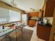 Cozy kitchen featuring wood cabinets, modern appliances, and tiled flooring at 205 Elinor S Ave, Dundee, FL 33838