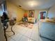 Cozy living room with white tiled floors, neutral decor, and comfortable seating arrangement at 205 Elinor S Ave, Dundee, FL 33838