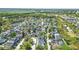 Scenic aerial view of a residential neighborhood with mature trees and a tranquil lake at 205 Norfolk Pl, Celebration, FL 34747