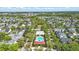 An aerial view shows a community pool, common areas, and single-Gathering homes in the residential neighborhood at 205 Norfolk Pl, Celebration, FL 34747