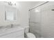 Modern bathroom featuring white tile shower with glass door and sleek vanity at 205 Norfolk Pl, Celebration, FL 34747