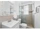 Bright bathroom featuring a glass enclosed shower, white vanity and mosaic mirror at 205 Norfolk Pl, Celebration, FL 34747