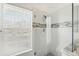 Modern bathroom featuring frameless shower glass, mosaic tile accents, and bright window at 205 Norfolk Pl, Celebration, FL 34747