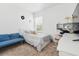 Cozy bedroom features a comfortable bed, workstation, and calming blue accent sofa at 205 Norfolk Pl, Celebration, FL 34747