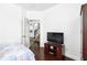 Cozy bedroom showcasing bed, dark wood furniture, wood floors, and view of stairs at 205 Norfolk Pl, Celebration, FL 34747