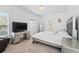 Cozy bedroom featuring a bed, desk, TV, and ample natural light at 205 Norfolk Pl, Celebration, FL 34747