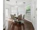 Bright dining room featuring wood floors, a glass table, and natural sunlight at 205 Norfolk Pl, Celebration, FL 34747